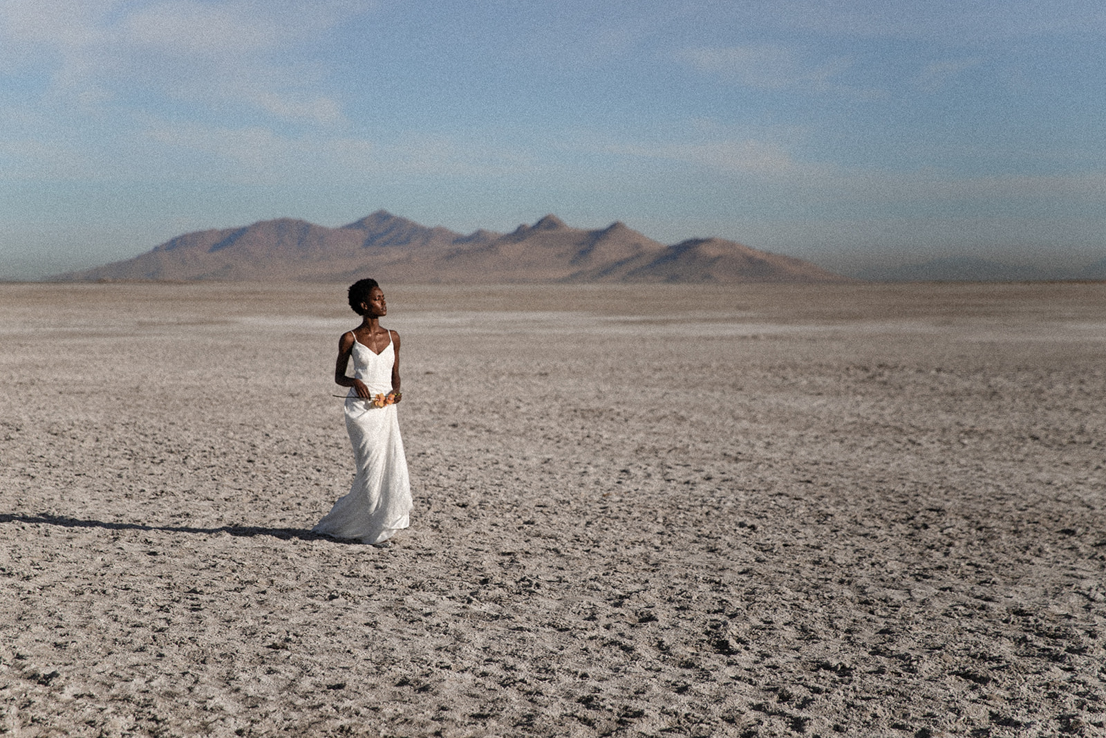 a person in a white dress in a desert