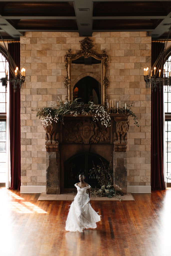 A bride walks in an ornate hall during an editorial wedding shoot