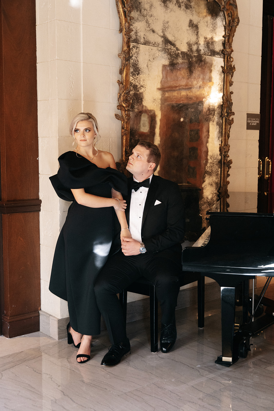 An elegantly dressed couple pose for their engagements at The St Regis in Washington DC, photographed by Kyla Jeanette Photography.