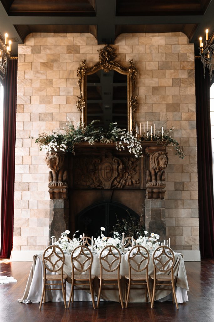 19 Luxury Wedding Ideas for an Elegant Celebration. Front view of fireplace with gold framed mirror.