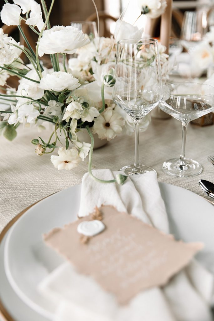 Close-up of the wedding reception menu on a plate at the reception table.