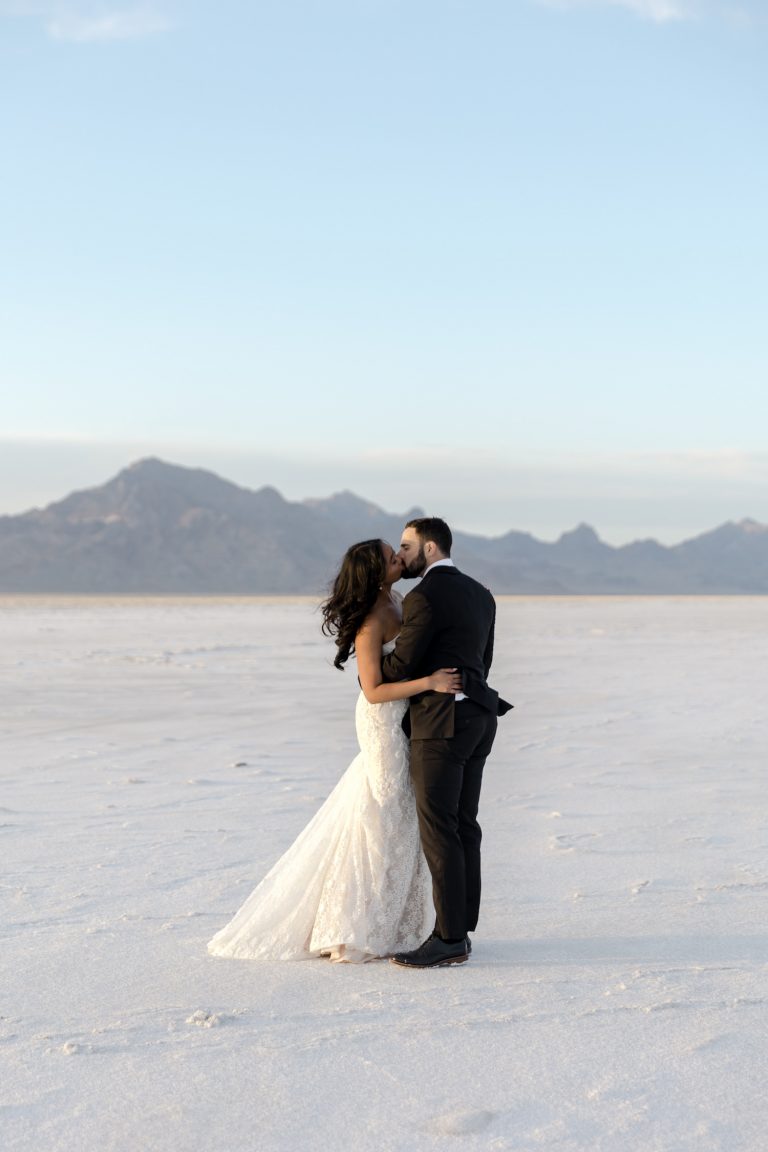 Bride and groom sharing a kiss during their Bonneville Salt Flats Wedding in Utah, taken by Kyla Jeanette Photography