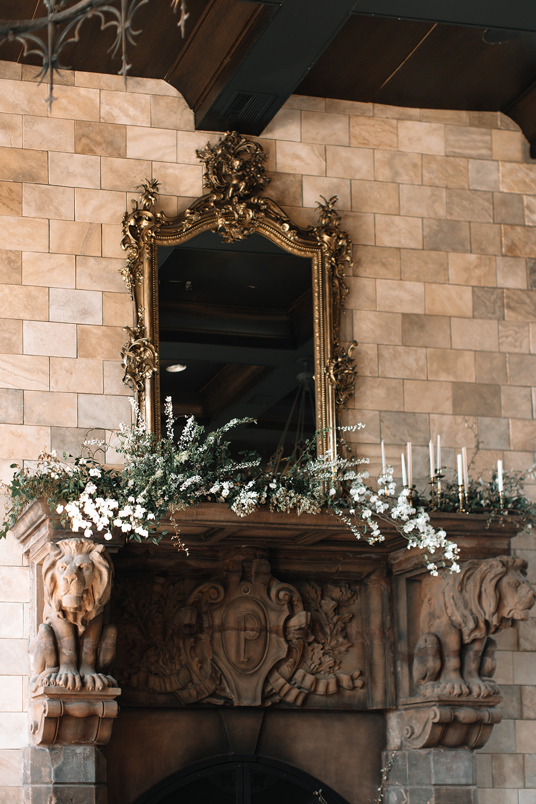 19 Luxury Wedding Ideas for an Elegant Celebration. Close-up of fireplace with gold framed mirror.