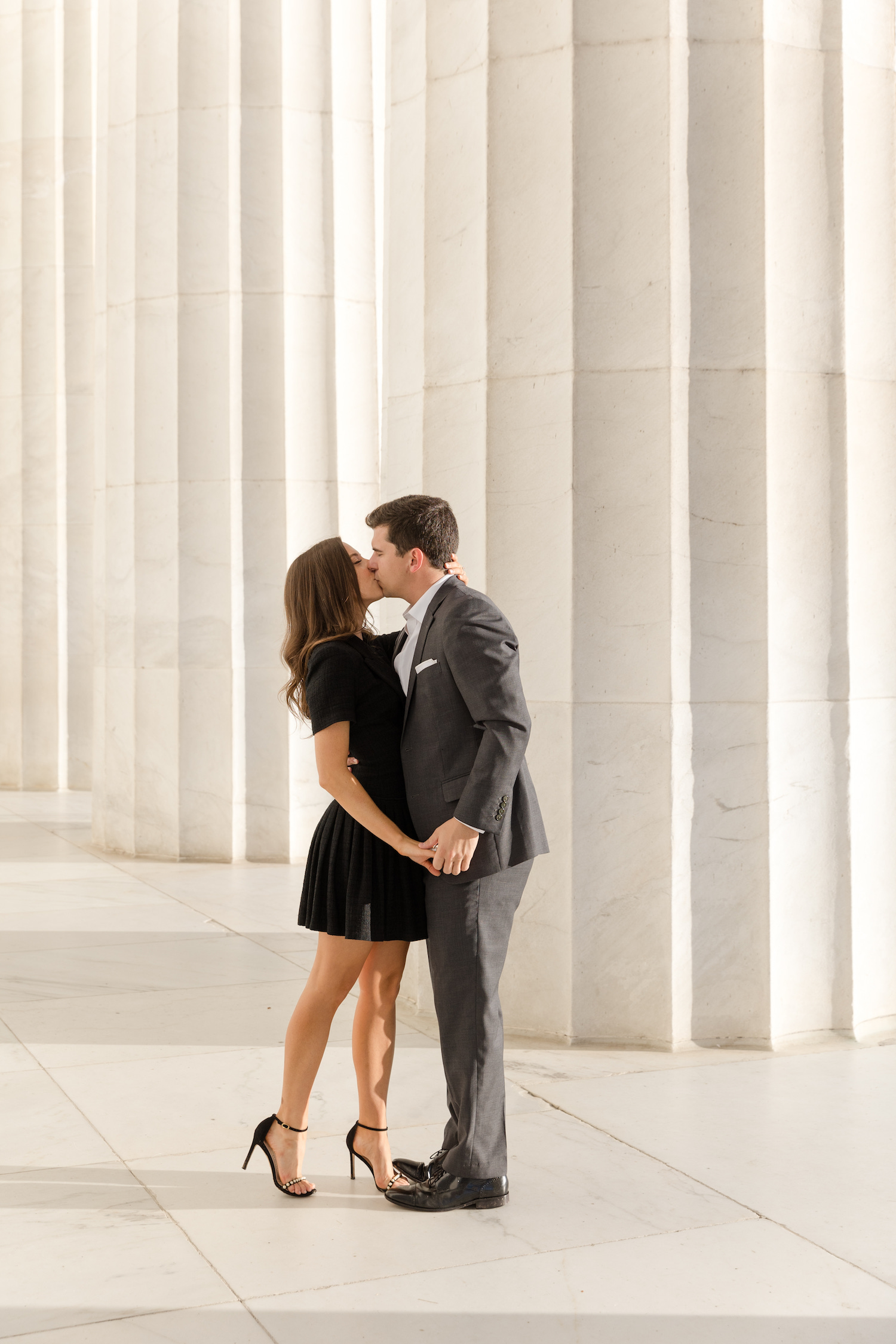 Dana and David sharing a kiss while holding hands during their elegant Washington engagement shoot with Kyla Jeanette