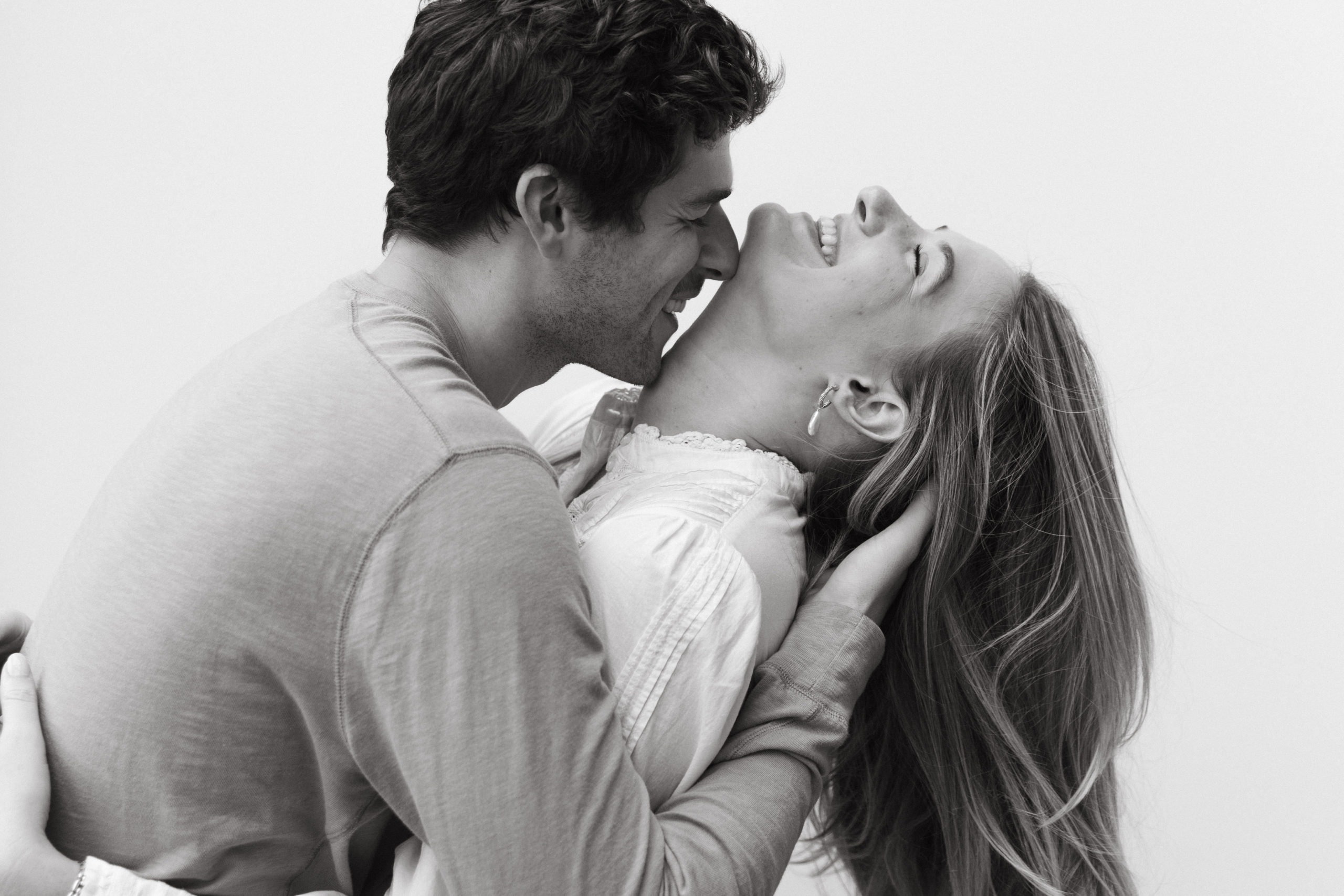 Chic and Minimalist Engagement Shoot: Hanna and Aidan playfully smiling and posing during their shoot with Kyla Jeanette