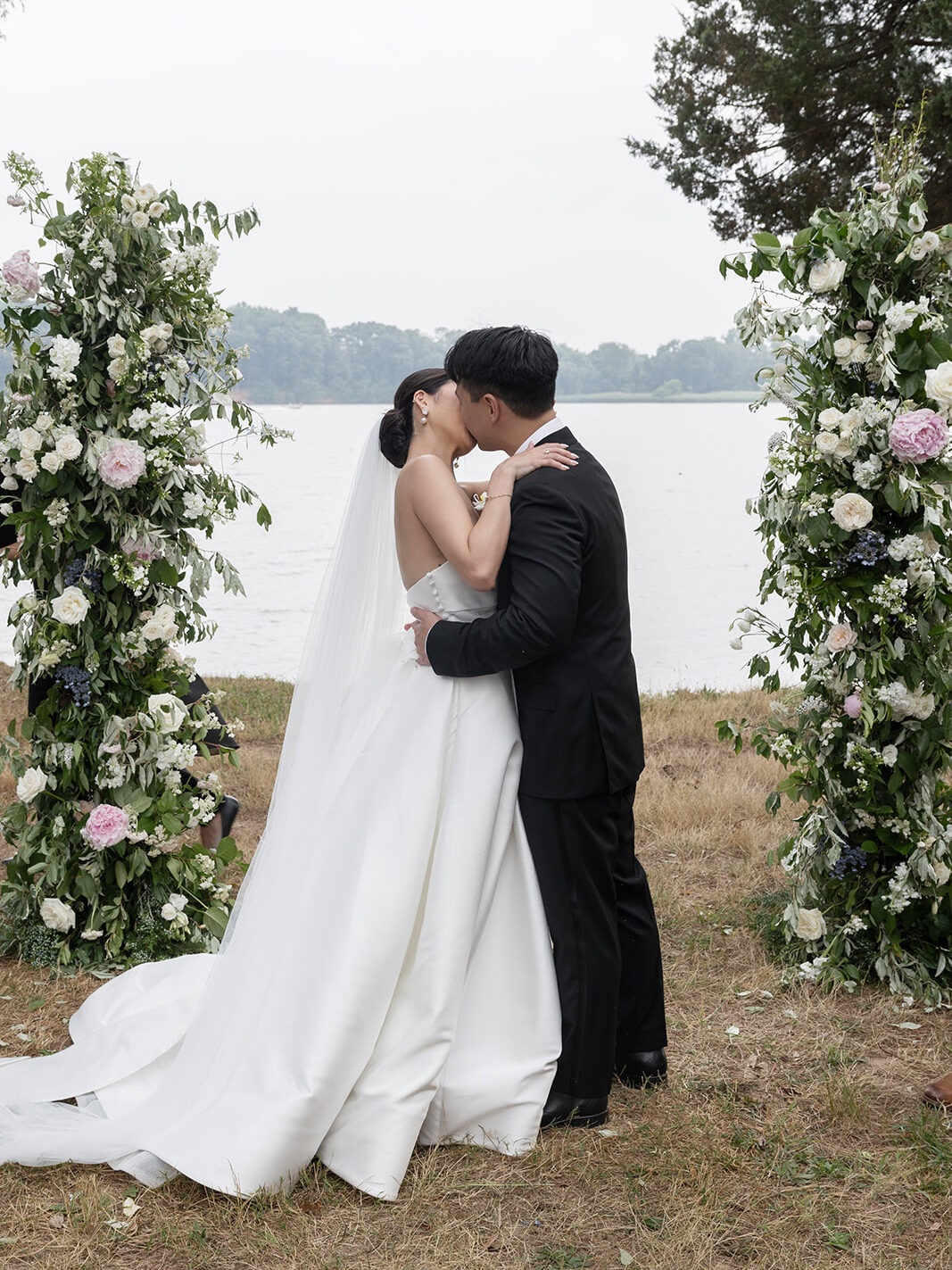 Bride and groom share their first kiss at the wedding altar