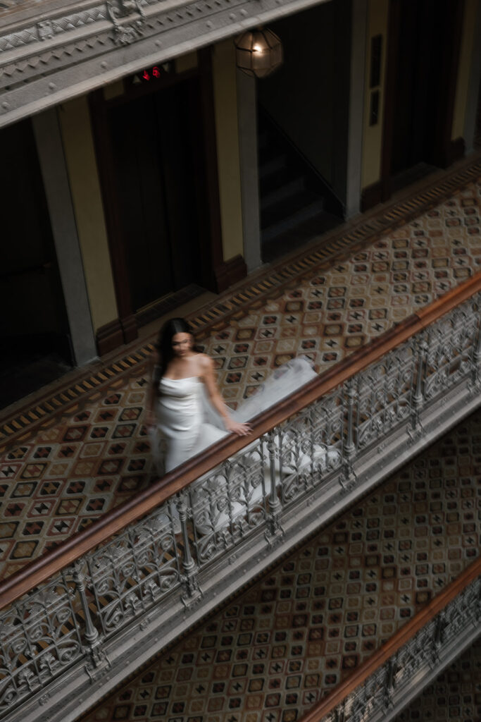 Bride walking through the hallways of the beekman